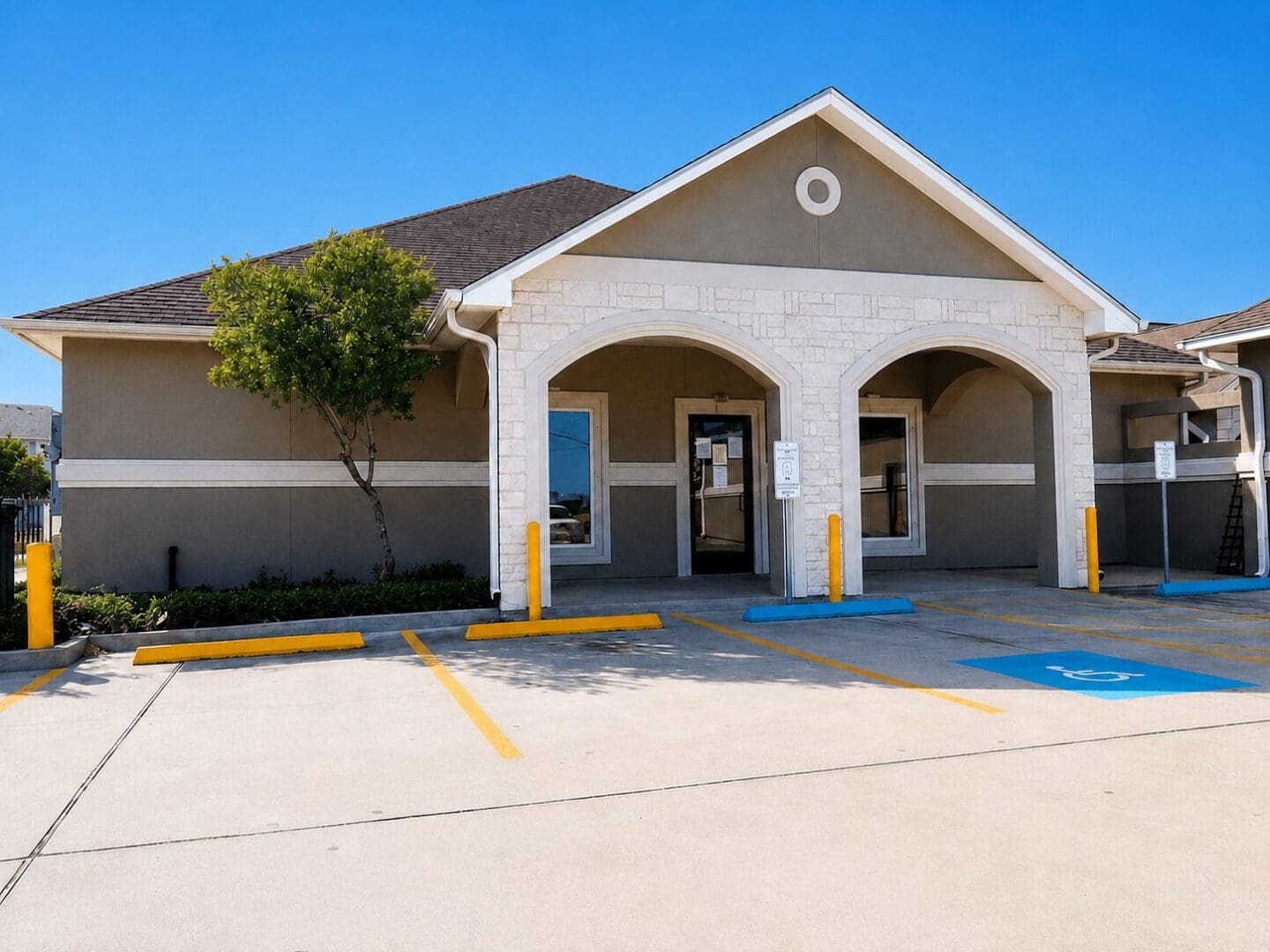 Small commercial building with arched stone entrance