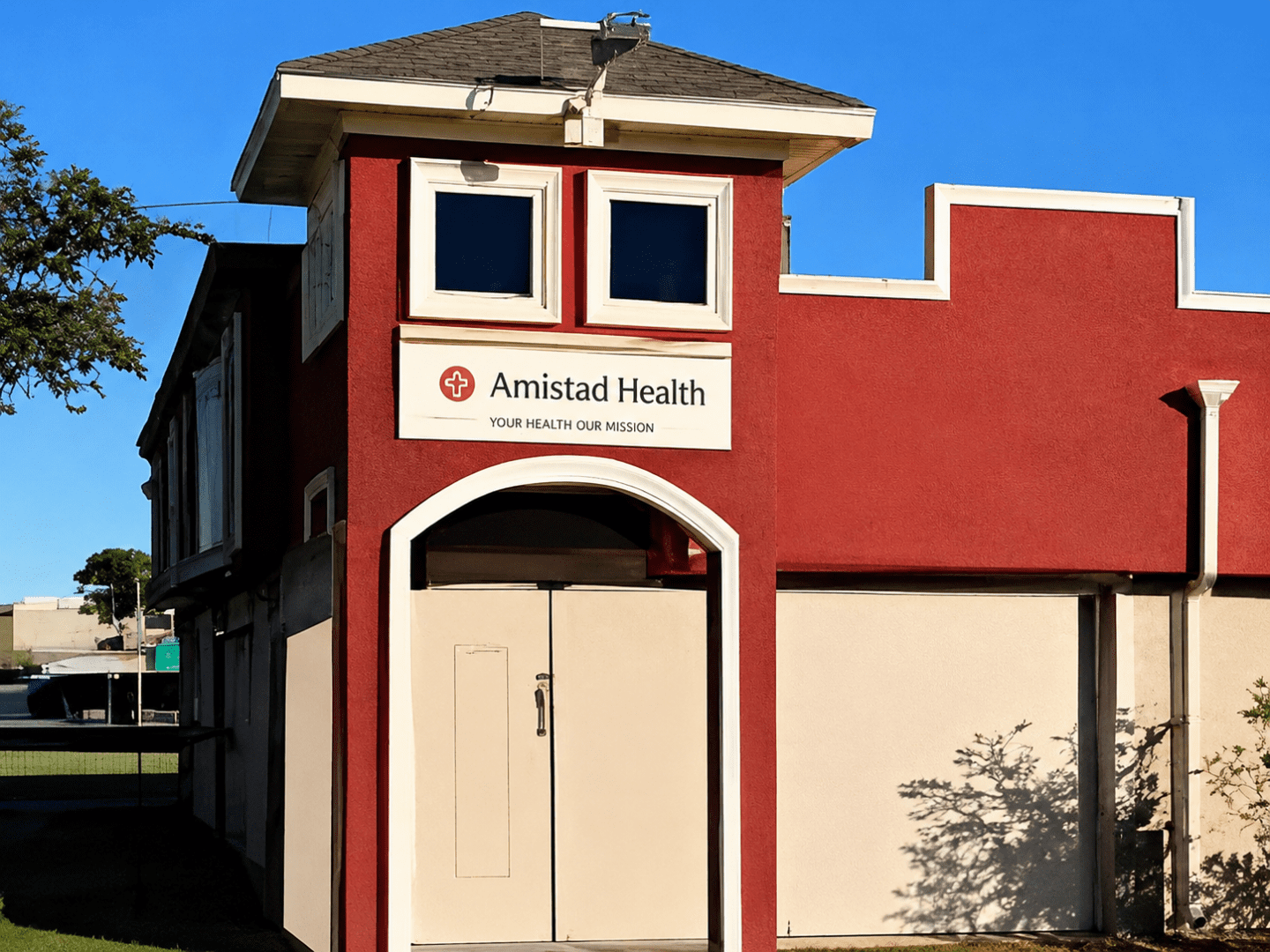 Red health clinic building with sign