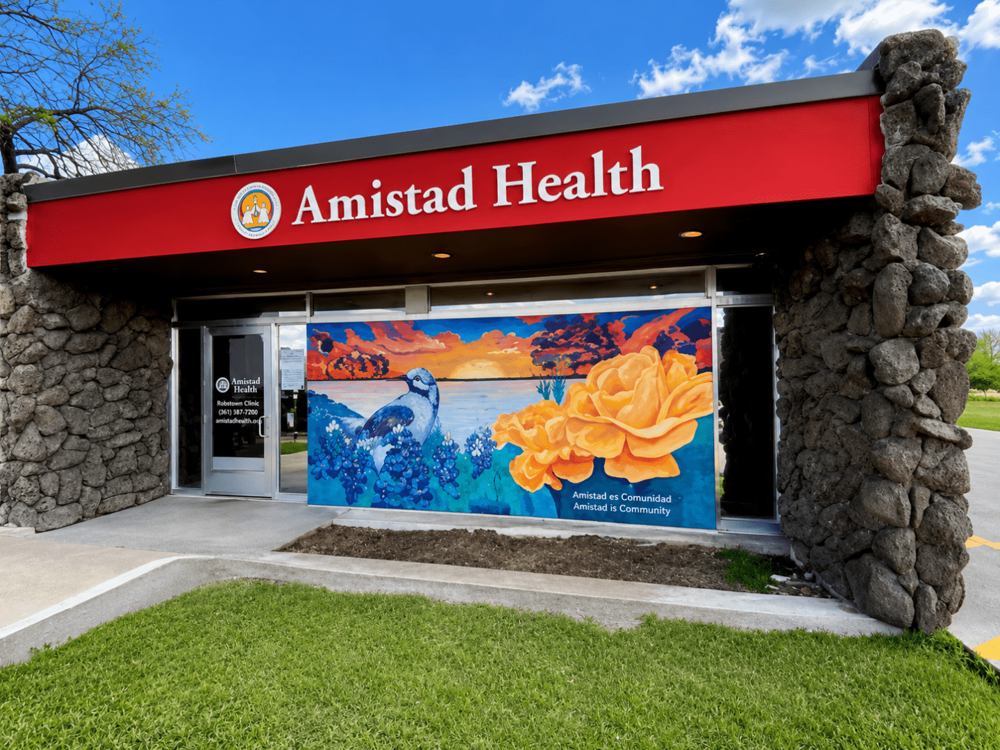 Amistad Health clinic storefront with colorful mural