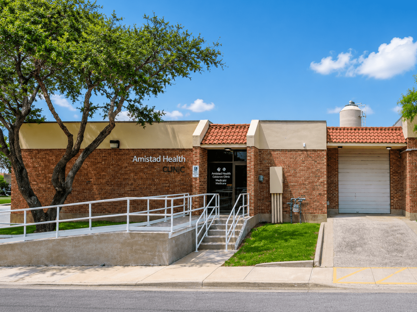 Clinic entrance with wheelchair ramp and tree